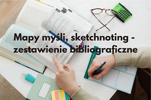 Dwie otwarte książki leżą na stoliku. Od dołu: dłonie osoby notującej na kartce.